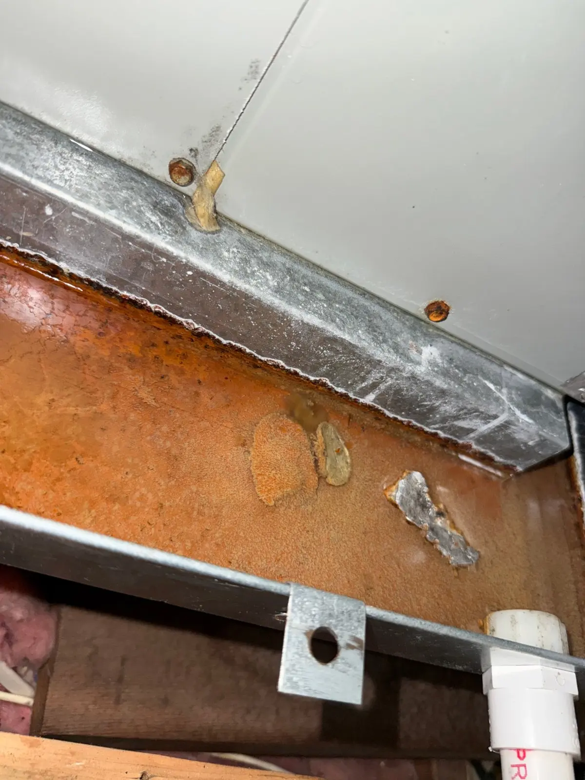 Rusted drain pan with standing water under the air handler, Bellmore NY
