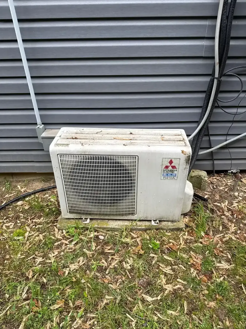 Outdoor mini-split unit beside a Commack home