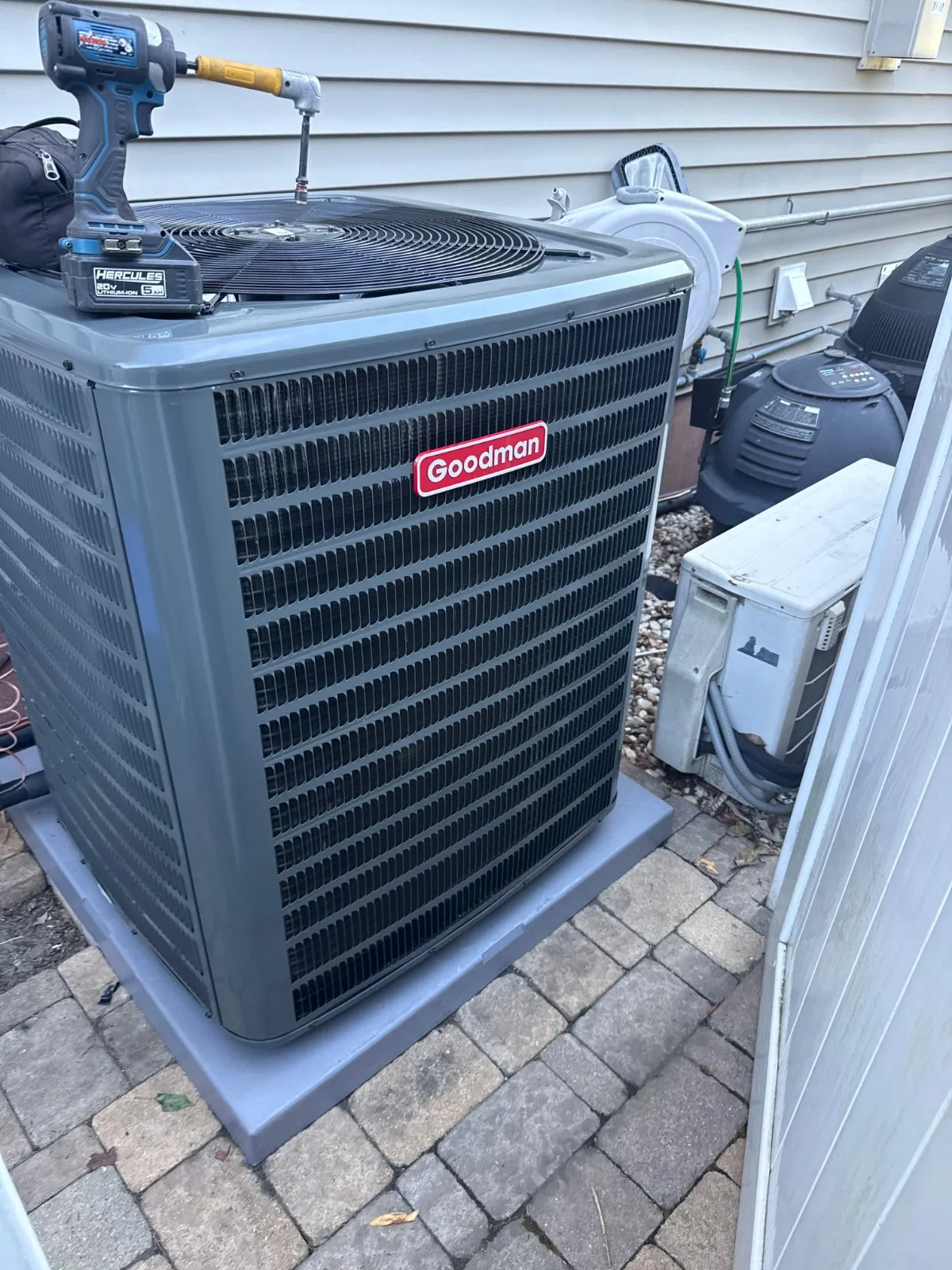 New Goodman condenser on its pad outside the house