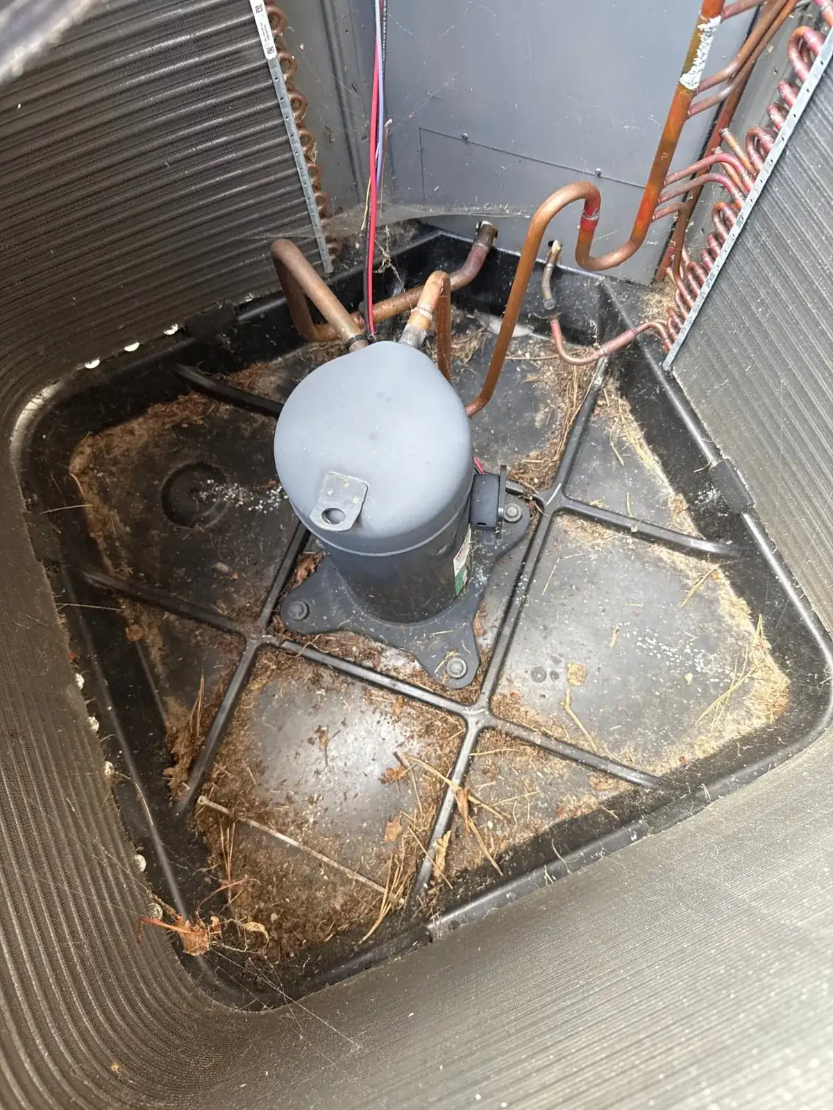 Inside the outdoor condenser before cleaning, Dix Hills NY